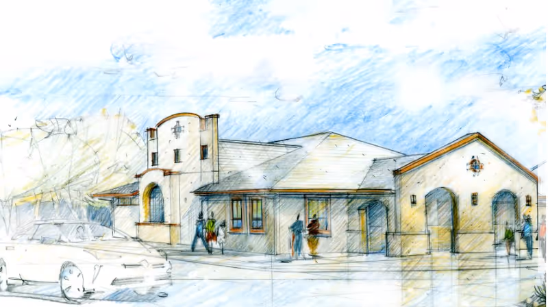 Exterior view of The Cottages of Tucson with people near the entrance.