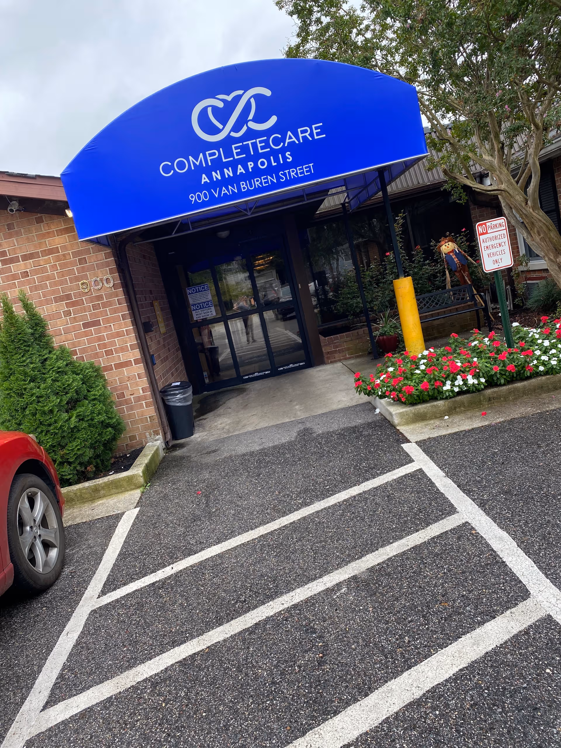 Blue curved canopy with Complete Care Annapolis signage over glass entrance at 900 Van Buren Street.