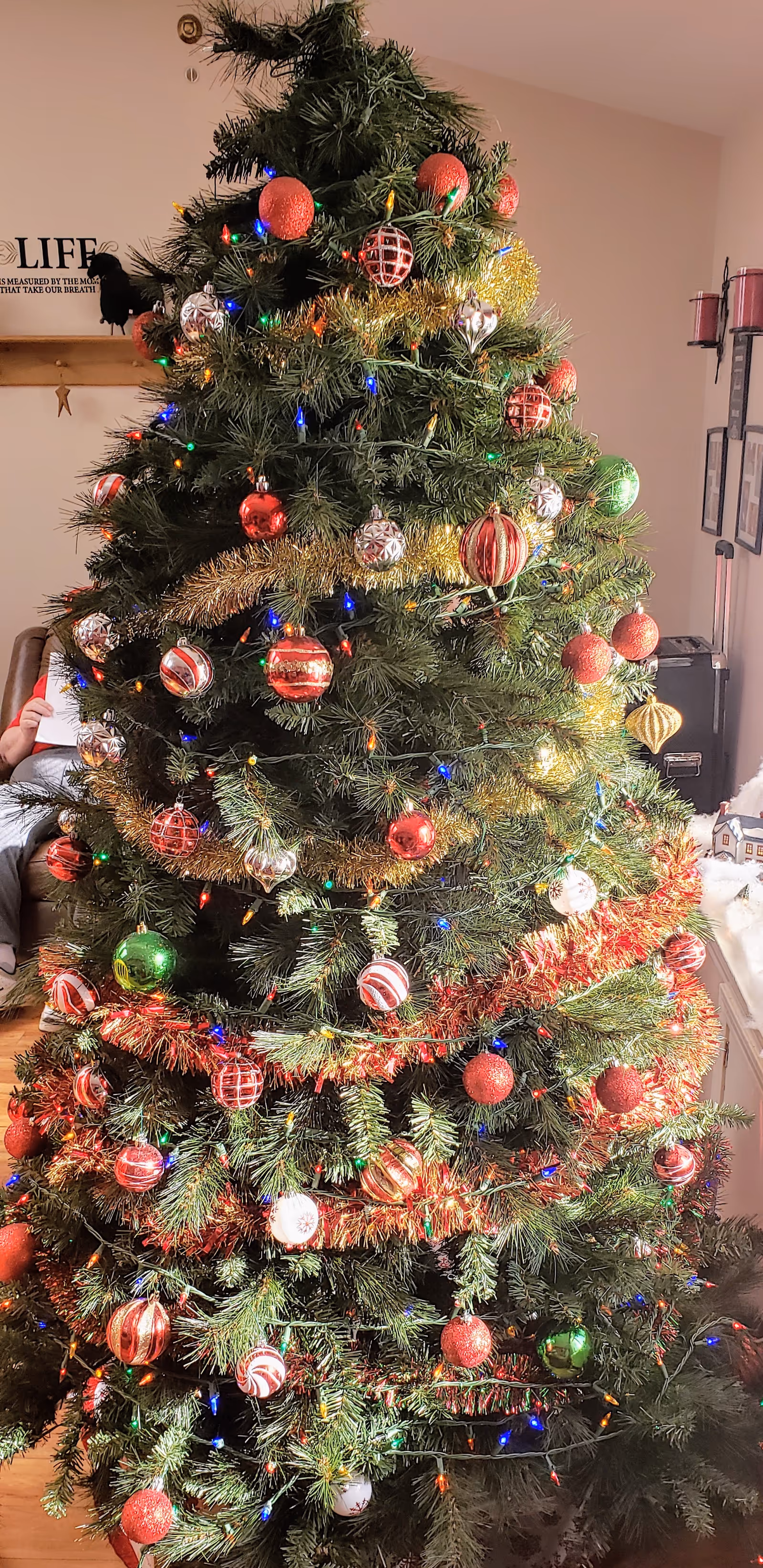 Tall indoor Christmas tree in a senior living facility common area.