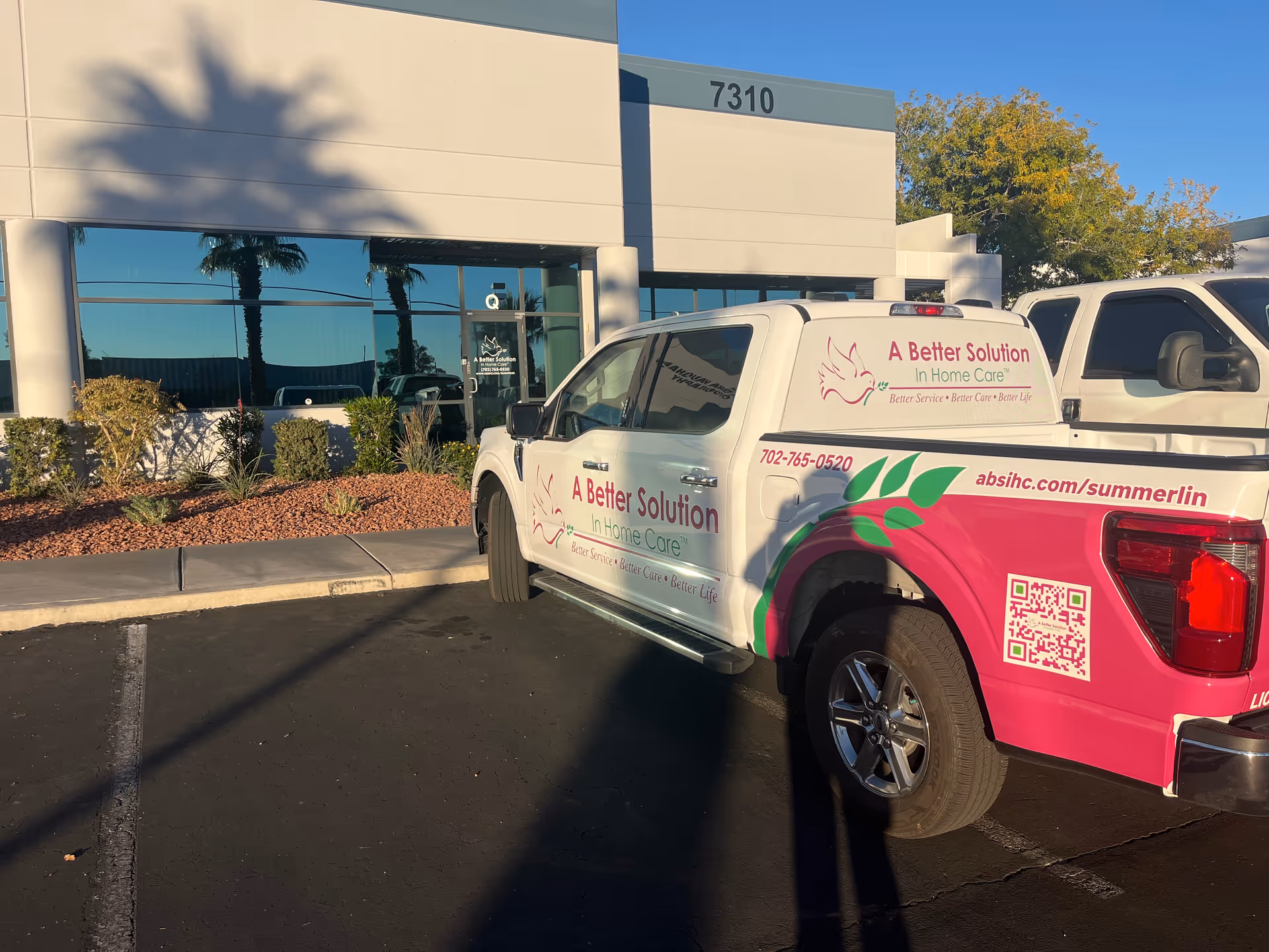 Exterior view of a facility with a branded A Better Solution home care truck.