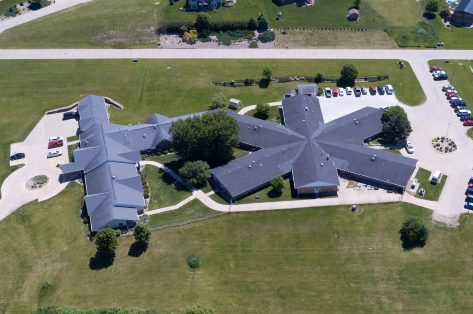Aerial view of Mica Hill Estates senior living campus with interconnected wings and parking