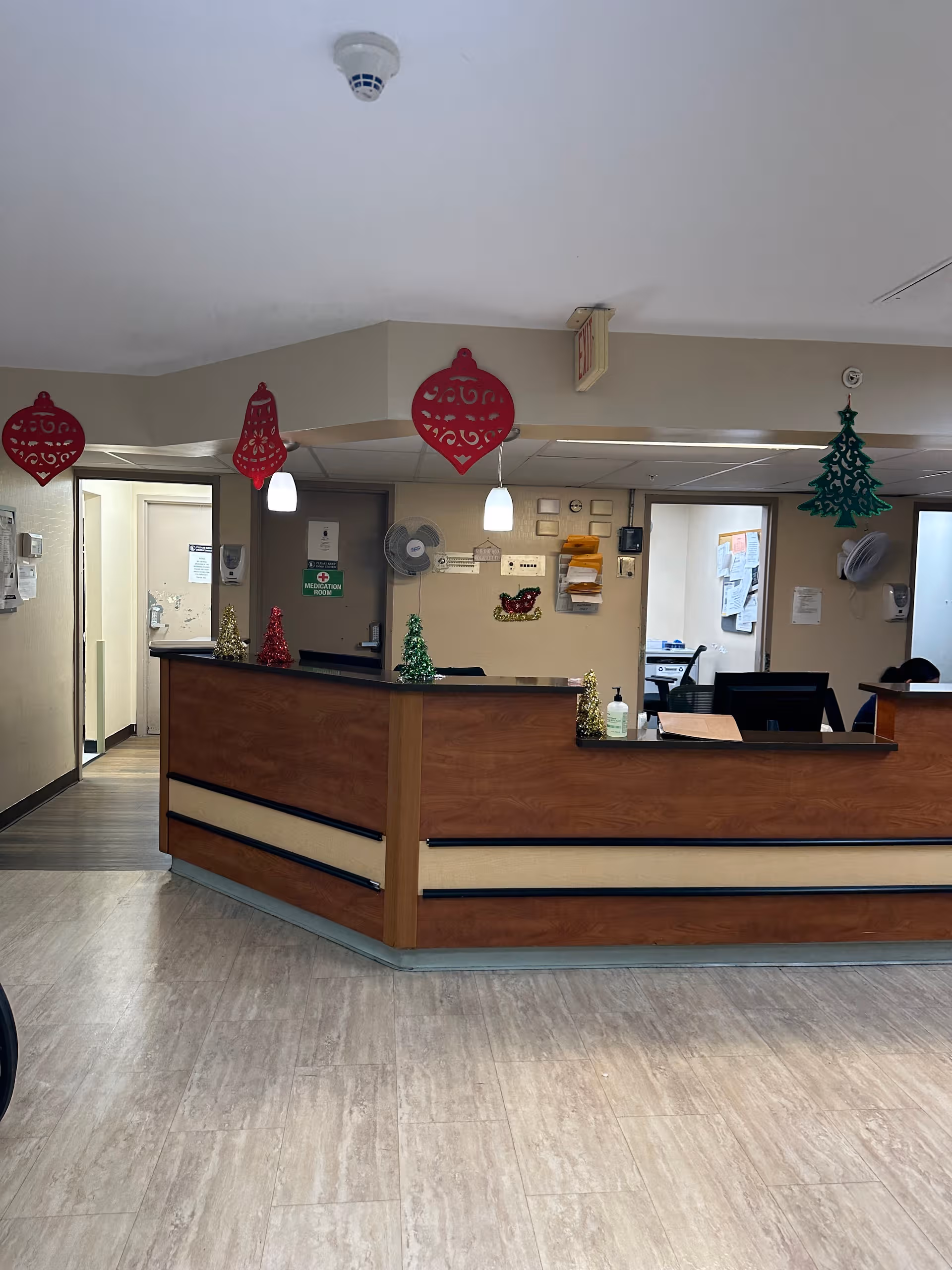 Reception desk in a senior living facility decorated with Christmas ornaments.