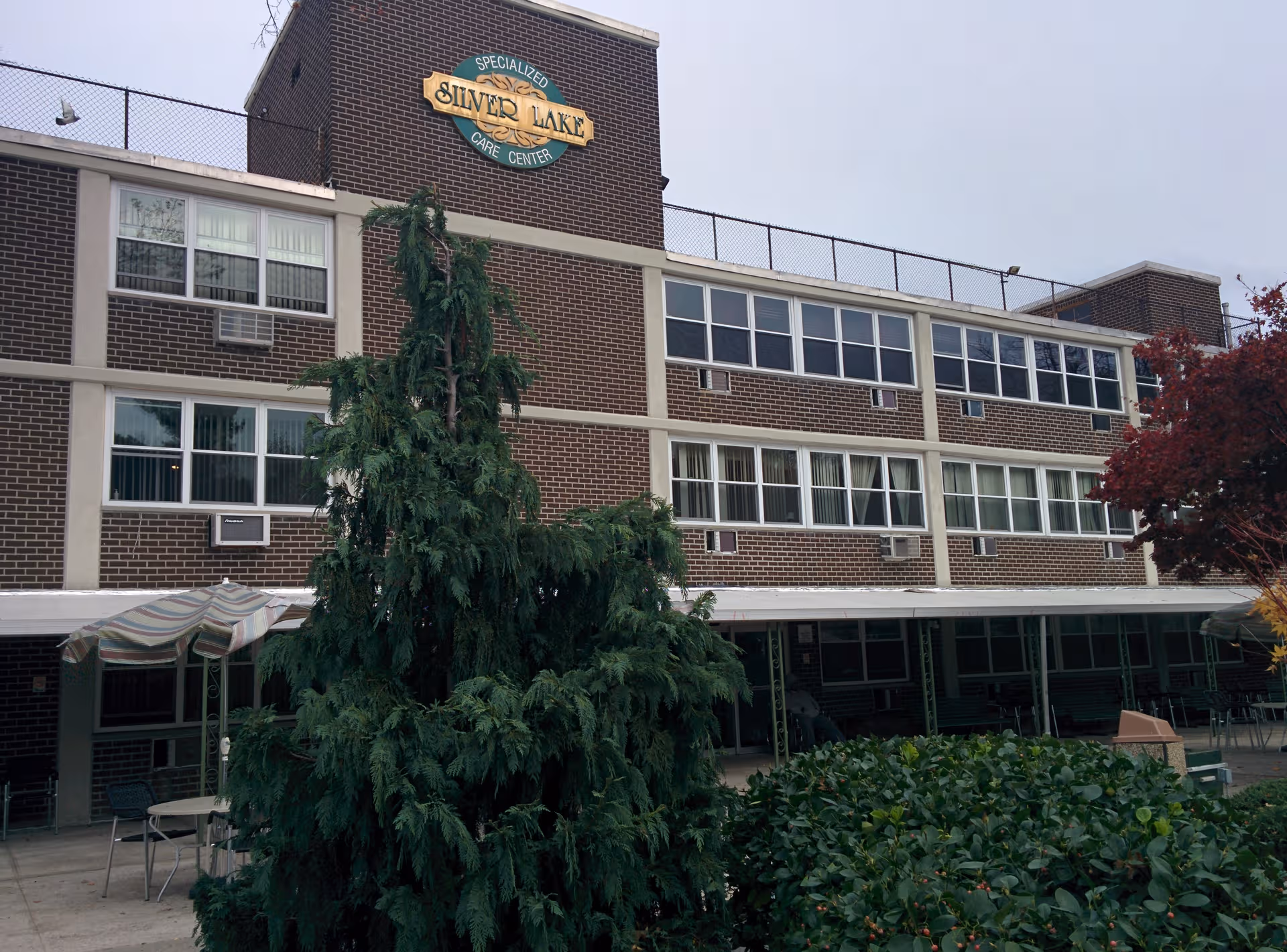 Exterior view of Silver Lake Specialized Care Center, brick building with trees.