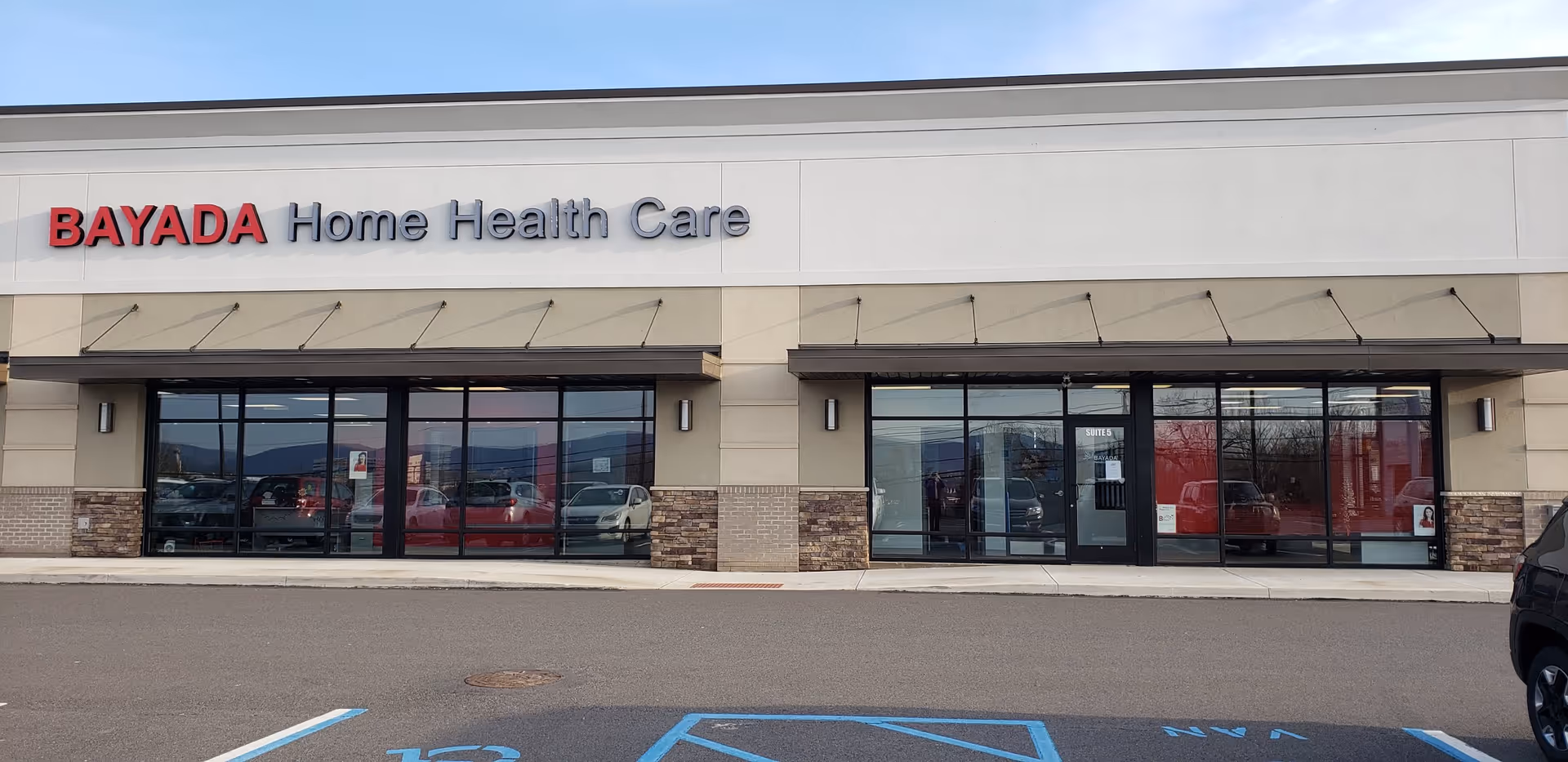 Exterior view of BAYADA Home Health Care building with large glass storefronts.