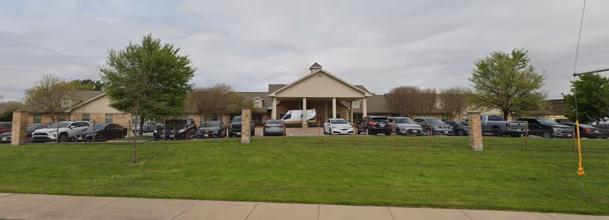 Front view of Pleasant Valley Healthcare Rehabilitation Center with cars in parking lot.
