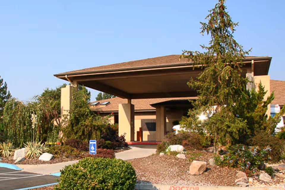 Exterior view of Life Care Center of Reno with a covered entrance and landscaping