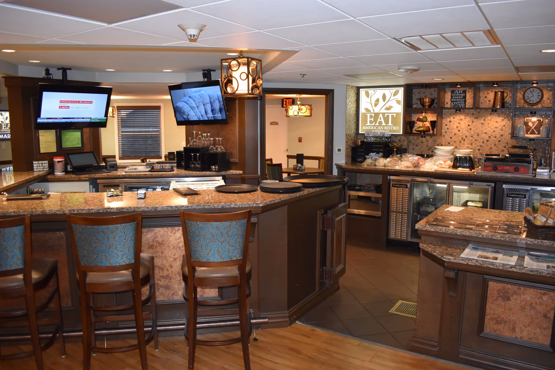 Cafe-style dining area inside The Inn at Freedom Village with bar stools.
