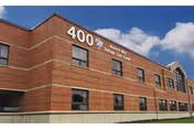 Exterior view of a brick senior care center with large '400' numbers on facade.