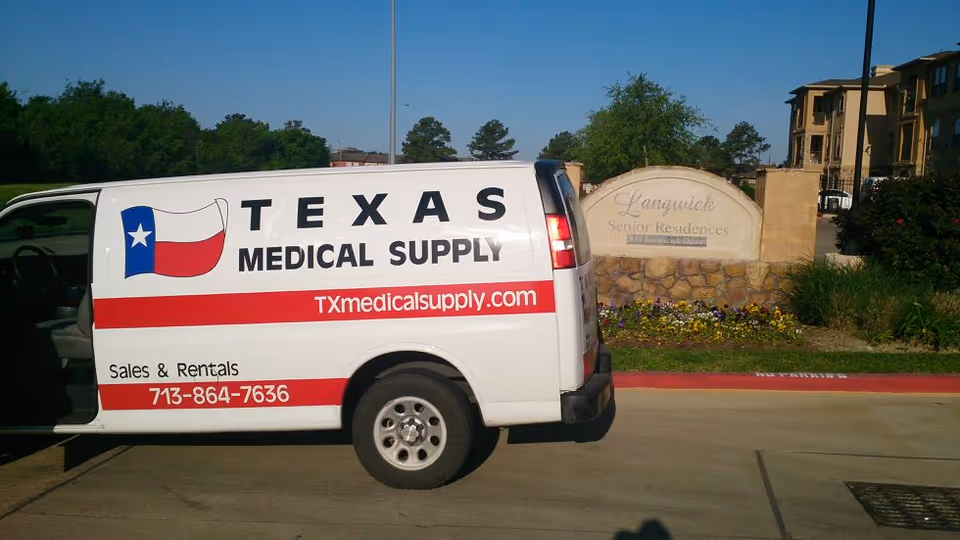 A white Texas Medical Supply van parked near Langwick Senior Residence sign and landscaping.