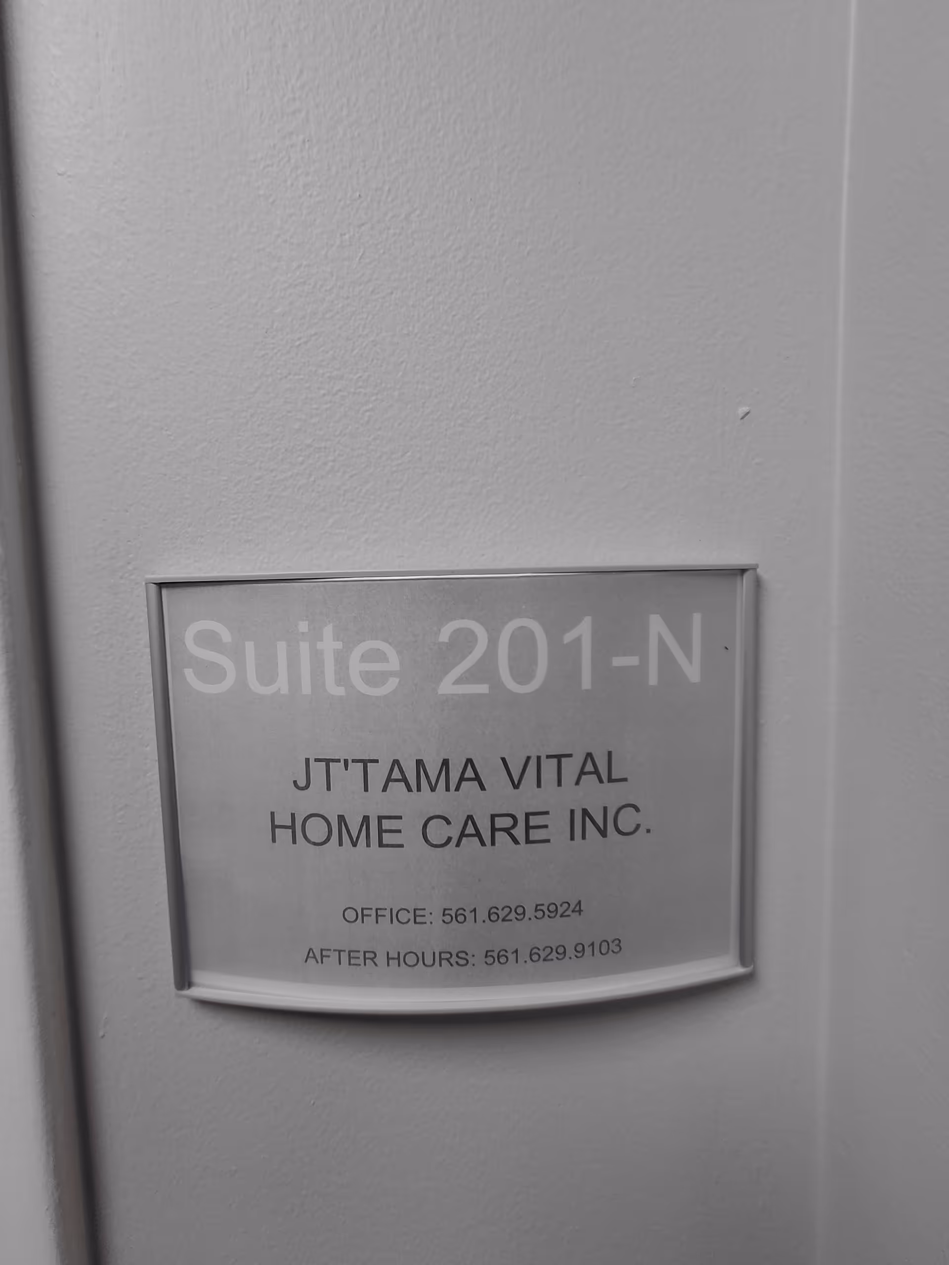 Wall sign reads Suite 201-N and JT'TAMA VITAL HOME CARE INC inside a hallway.