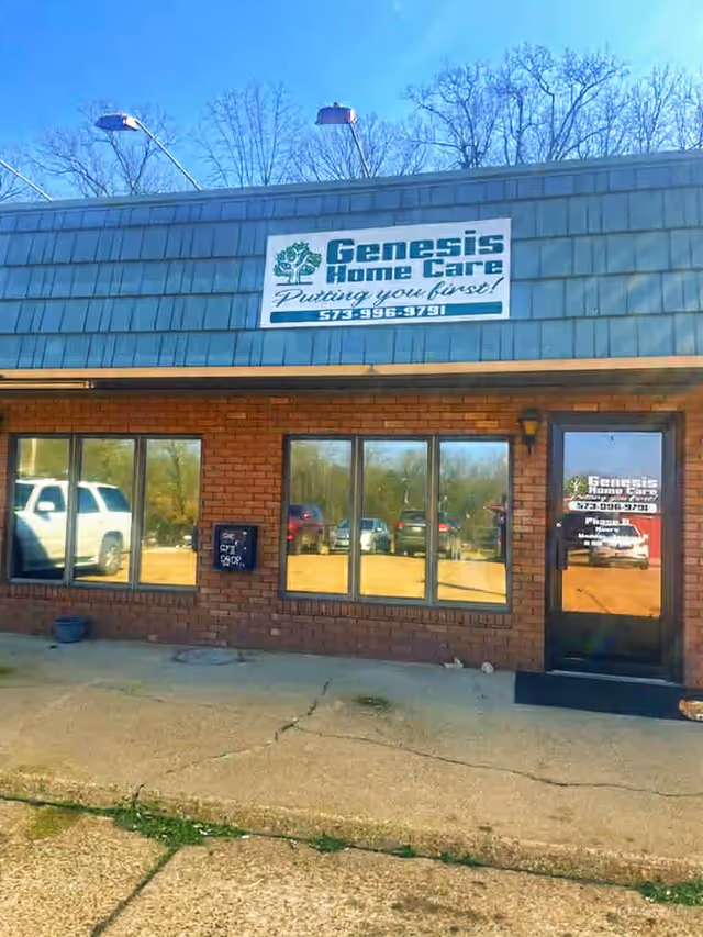 Exterior view of Genesis Home Care building with sign and large window storefront.