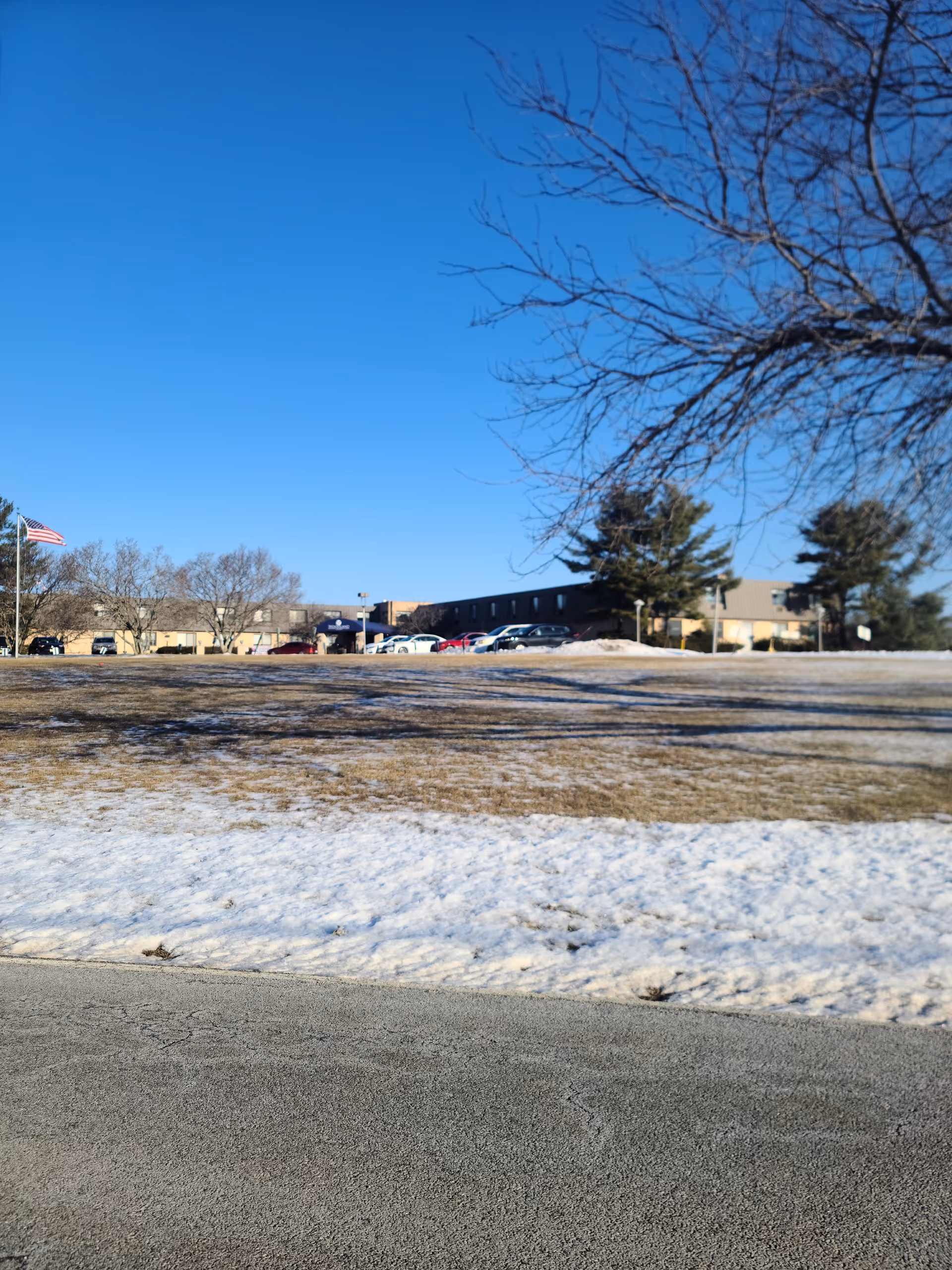 Exterior view of Andover Subacute and Rehab II with parked cars and snow.