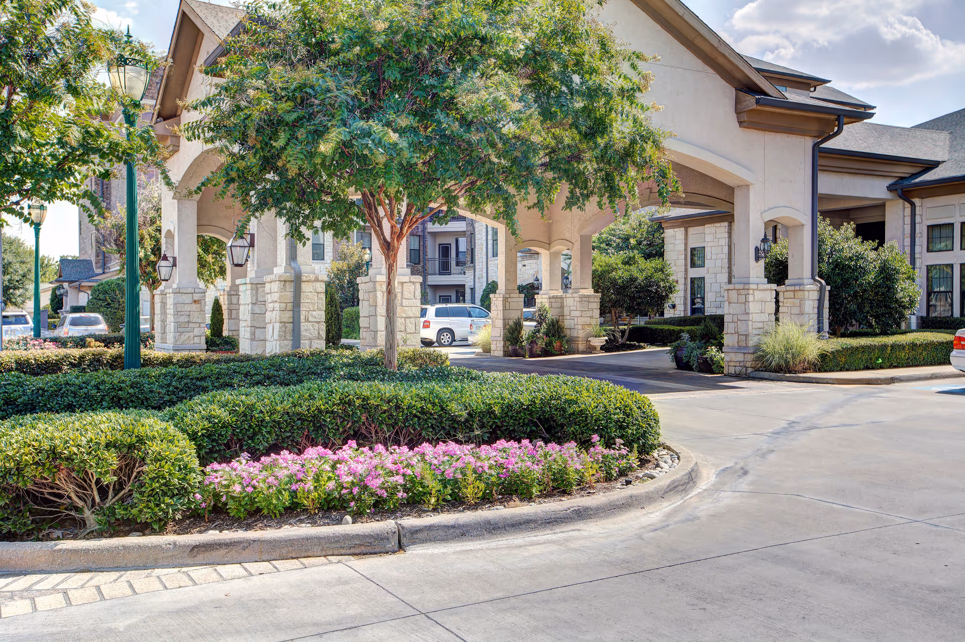 Entry archway and landscaped circle drive in front of Conservatory at Keller Town Center.
