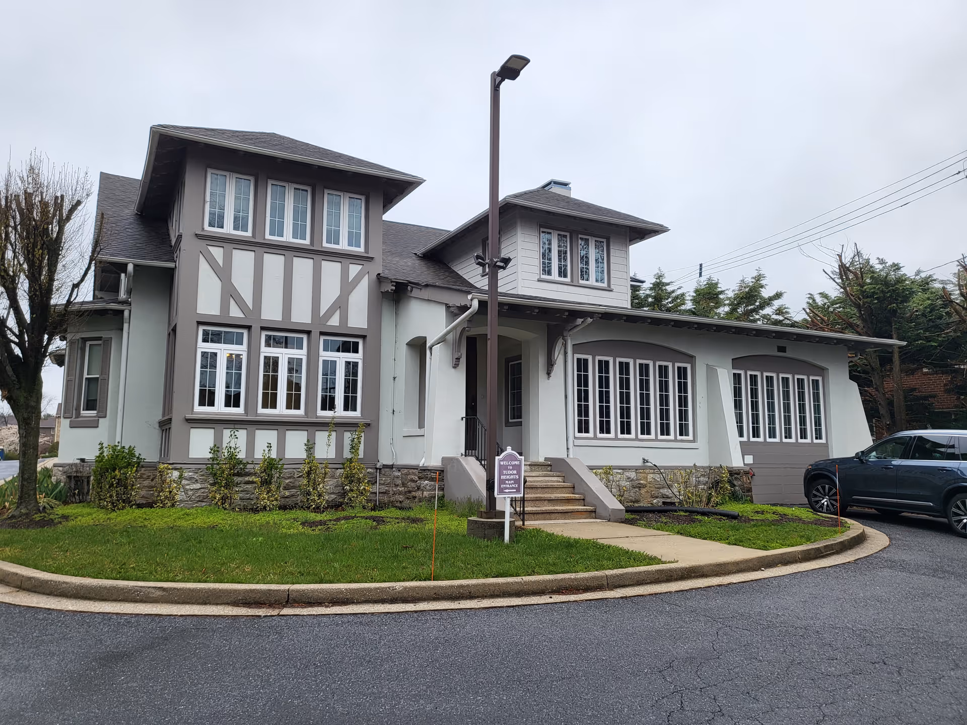 Aventura at the Heights exterior with Tudor-style facade, large windows, and a curved driveway.