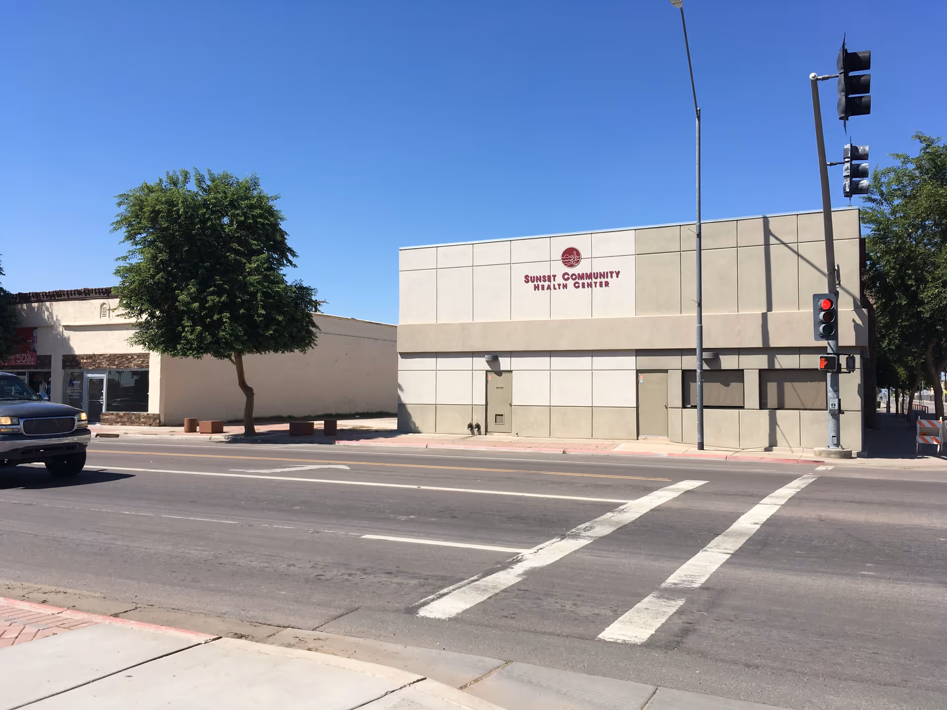 A street view shows a beige building labeled Sunset Community Health Center.