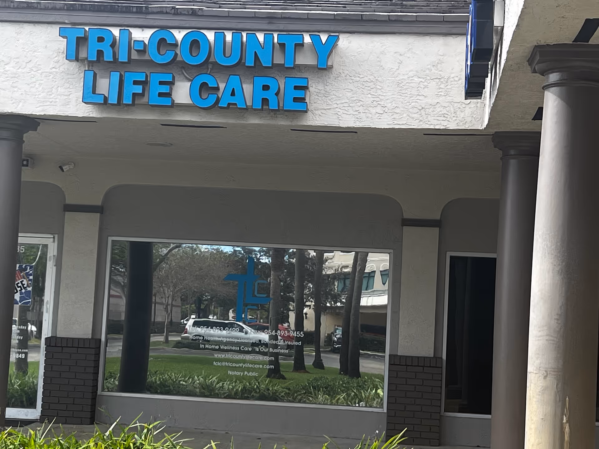 Exterior front of Tri-County Life Care building with a blue sign and columns.