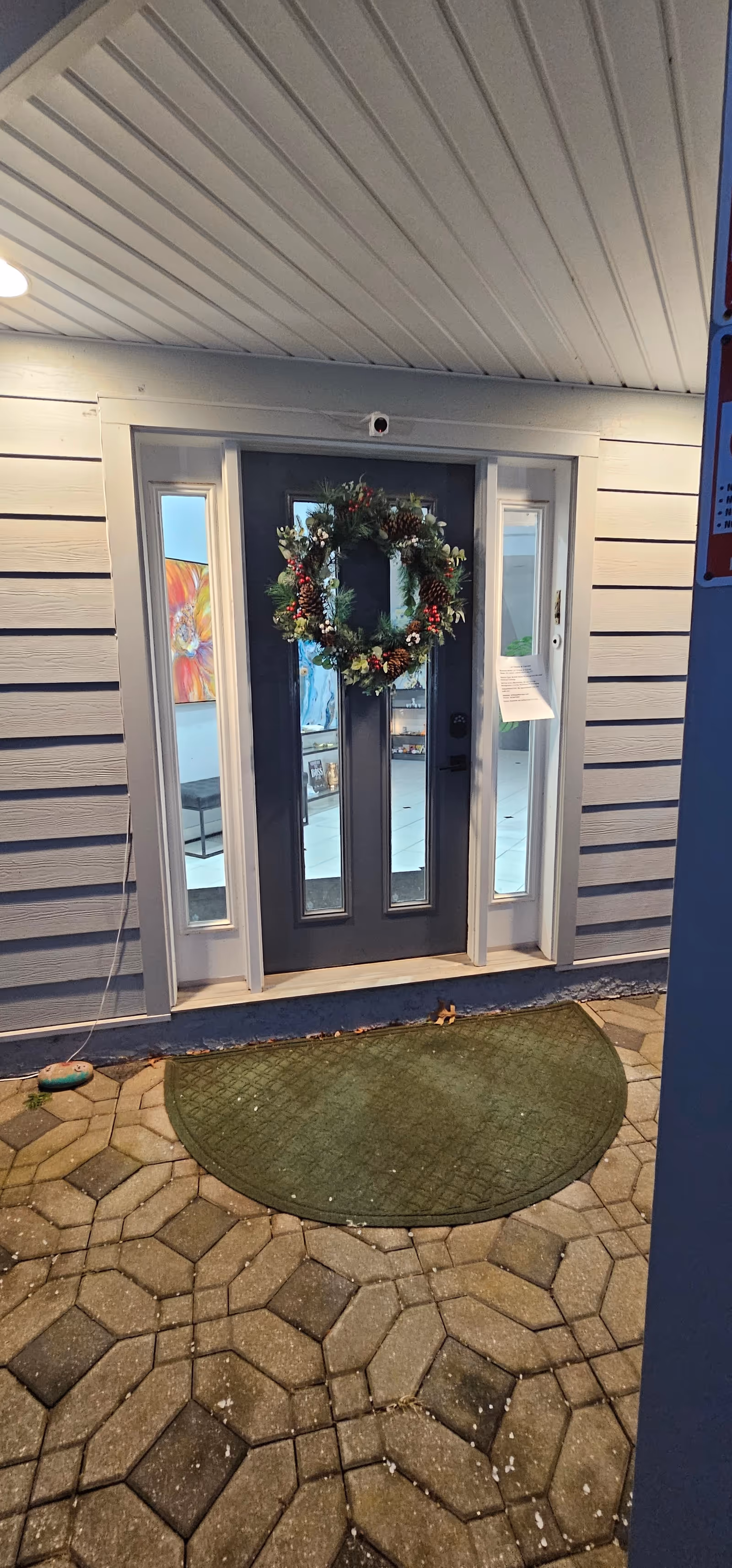 Entering doorway of LK Fitness & Therapy building with wreath and glass panels.