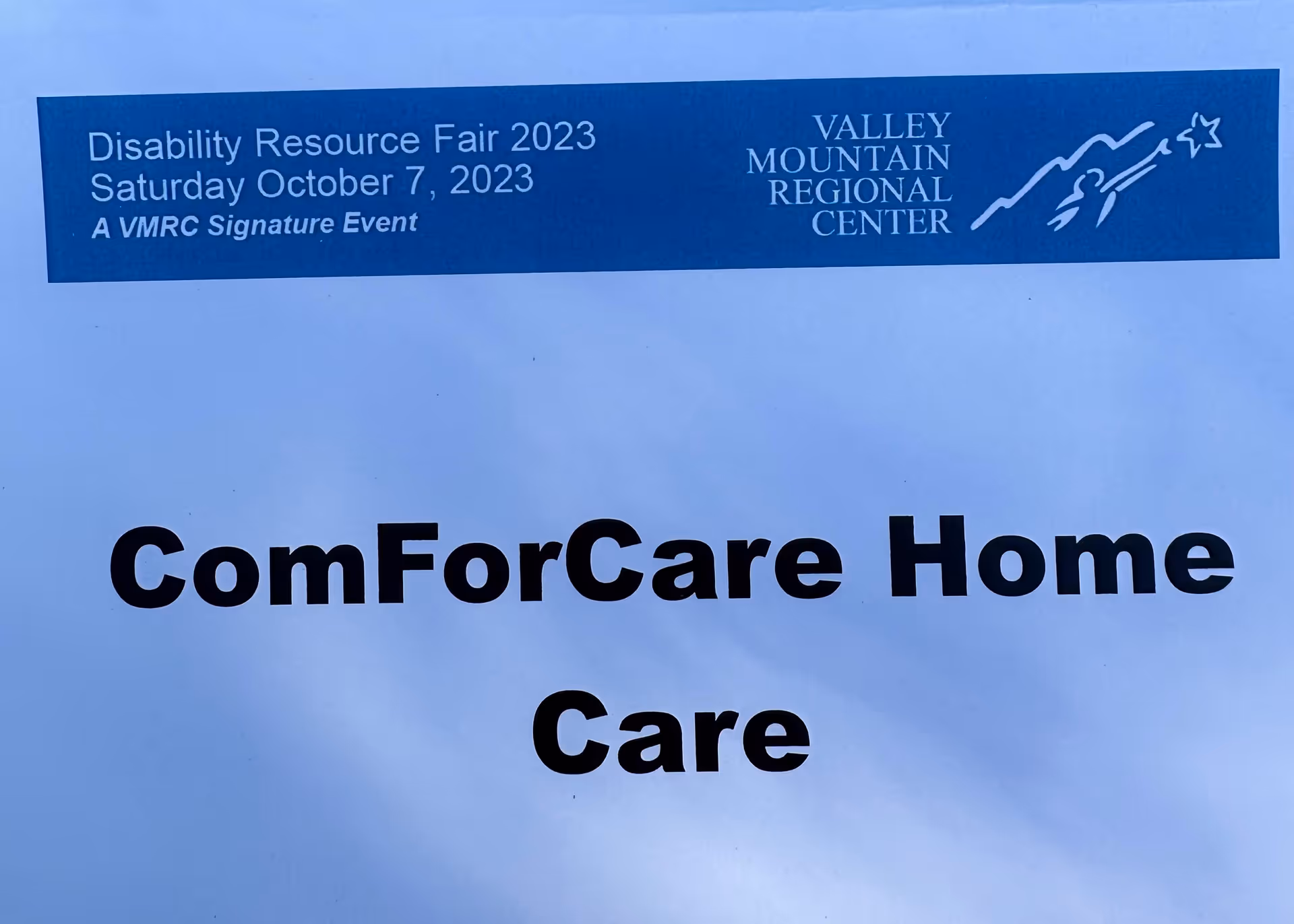 Front-facing building sign displaying ComForCare Home Care with Disability Resource Fair banner.
