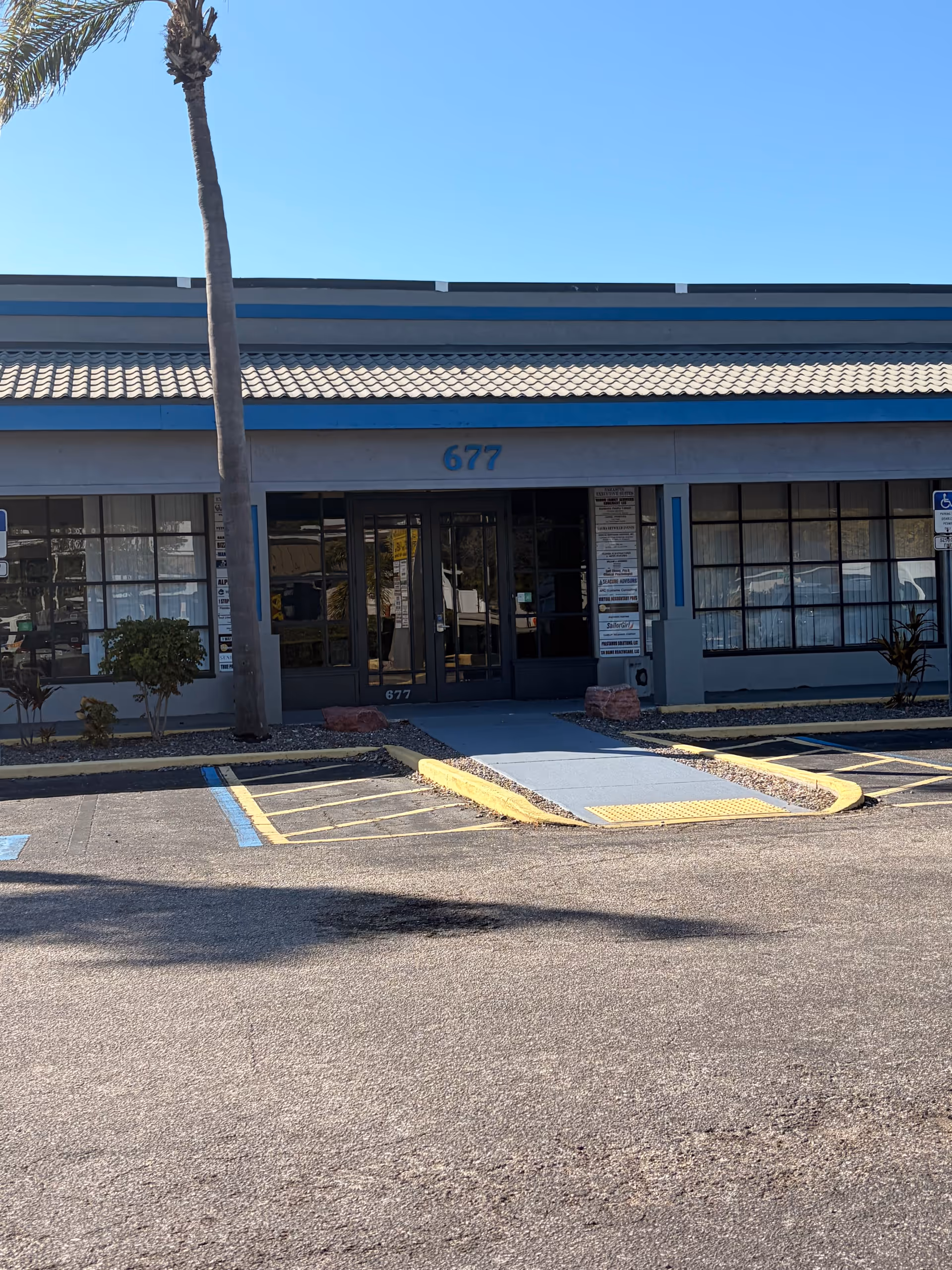 Front view of Creative Caregivers of Florida facility entrance with blue trim