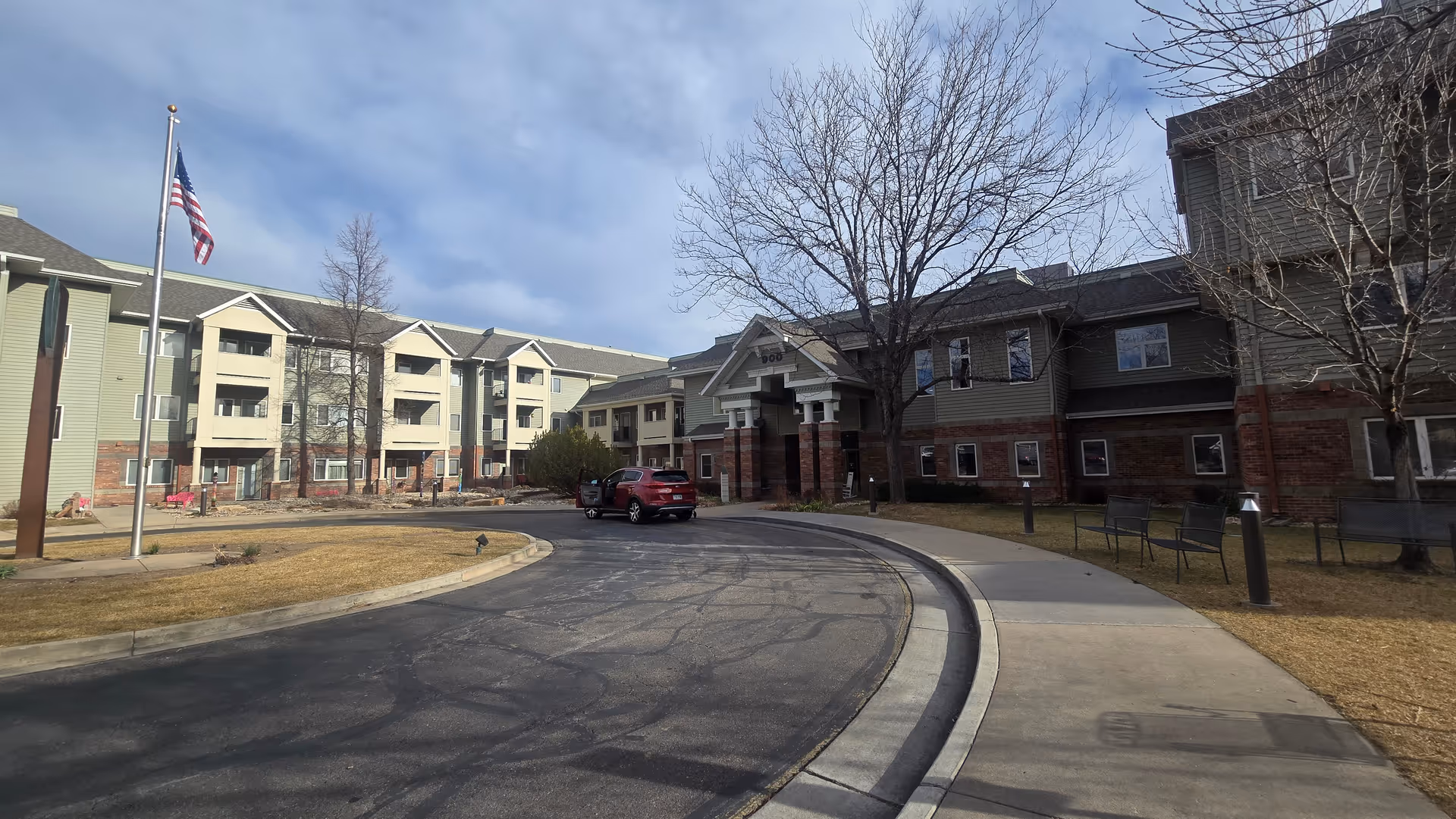 Exterior view of Worthington senior living center with curved driveway and flagpole