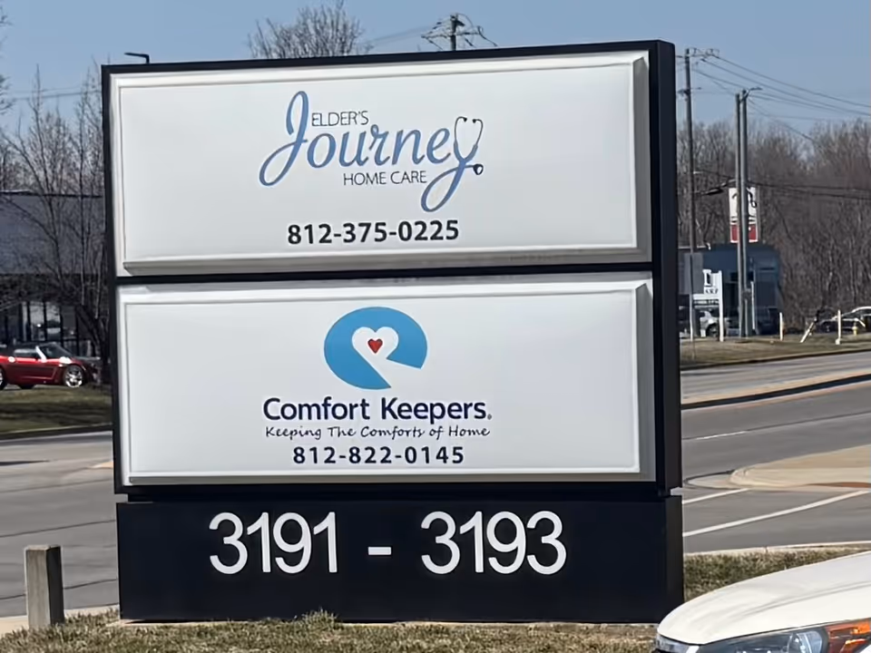 Exterior signboard displays Elder's Journey Home Care and Comfort Keepers branding with phone numbers.