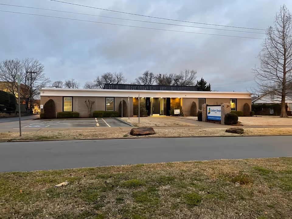 Front view of Golden Steps ABA Autism Therapy Center, a single-story building with a lit entrance.