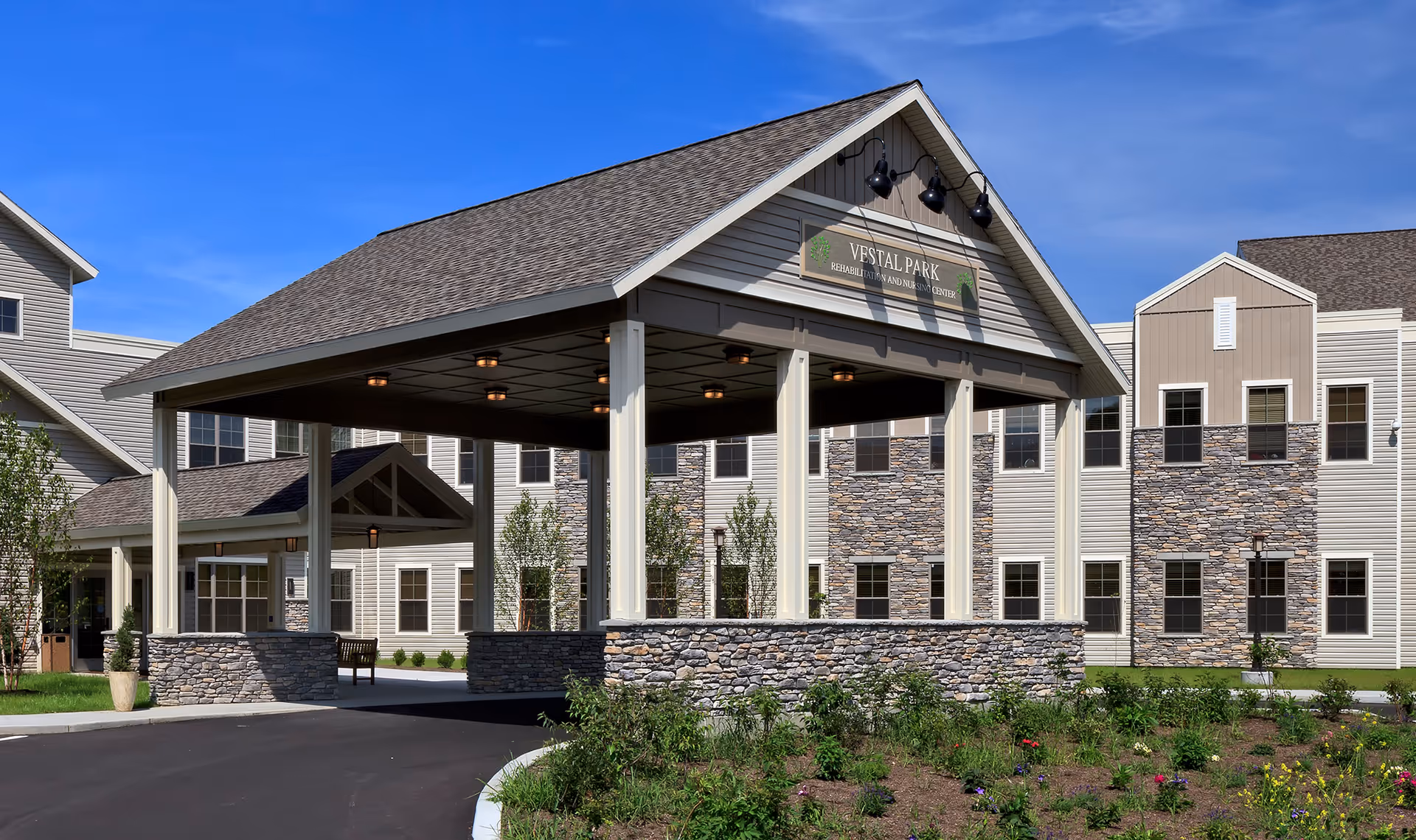 Front exterior view of Vestal Park Rehabilitation and Nursing Center entrance under a porte-cochère