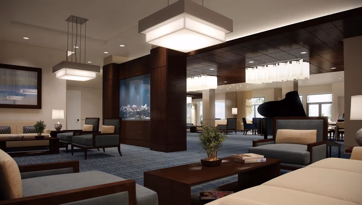 Spacious modern lounge with seating areas, a central fish tank, large hanging lights and a grand piano.
