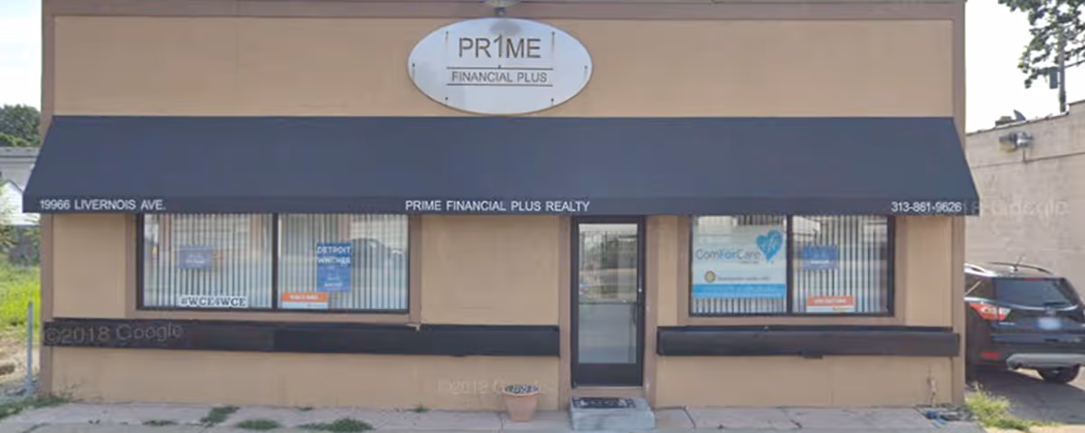Storefront building with black awning, two windows, center door, ComForCare signs visible.