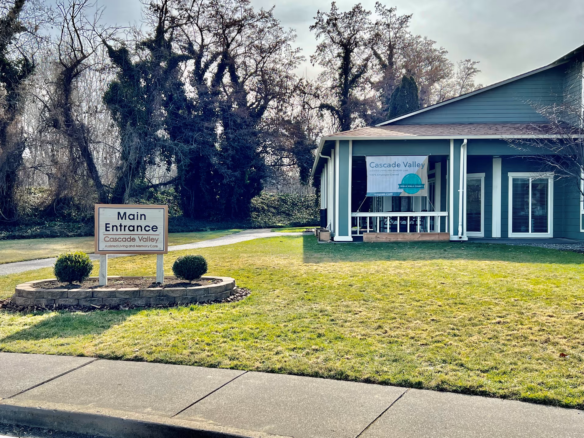 Exterior view of Cascade Valley building with Main Entrance sign and lawn