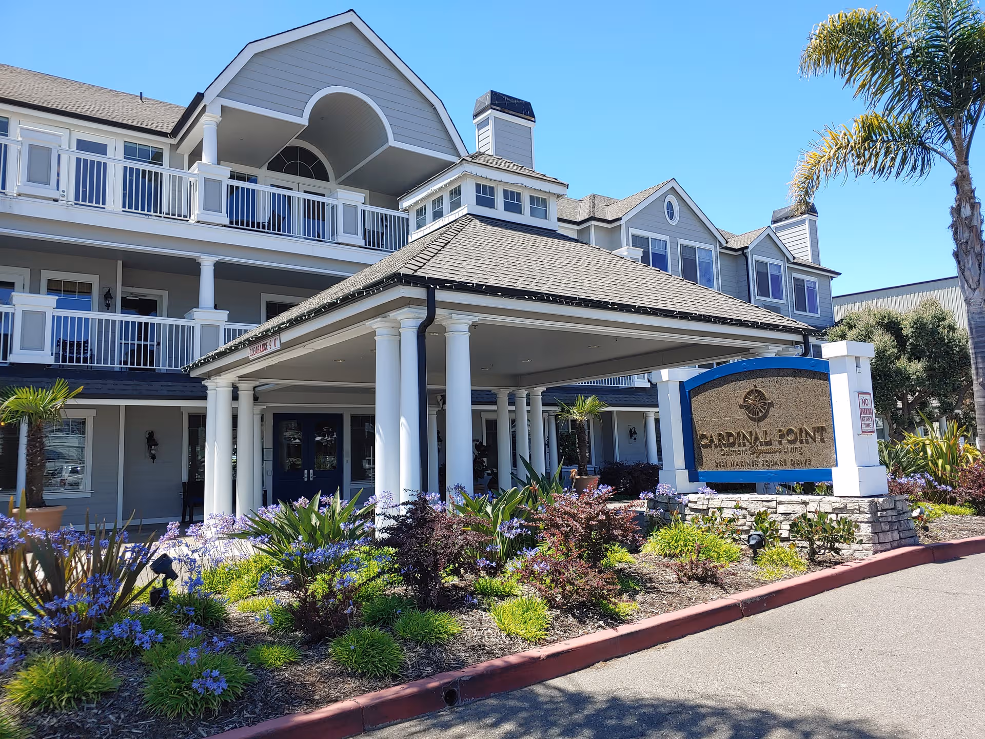 Facade of Cardinal Point senior living with a covered entrance and balconies.