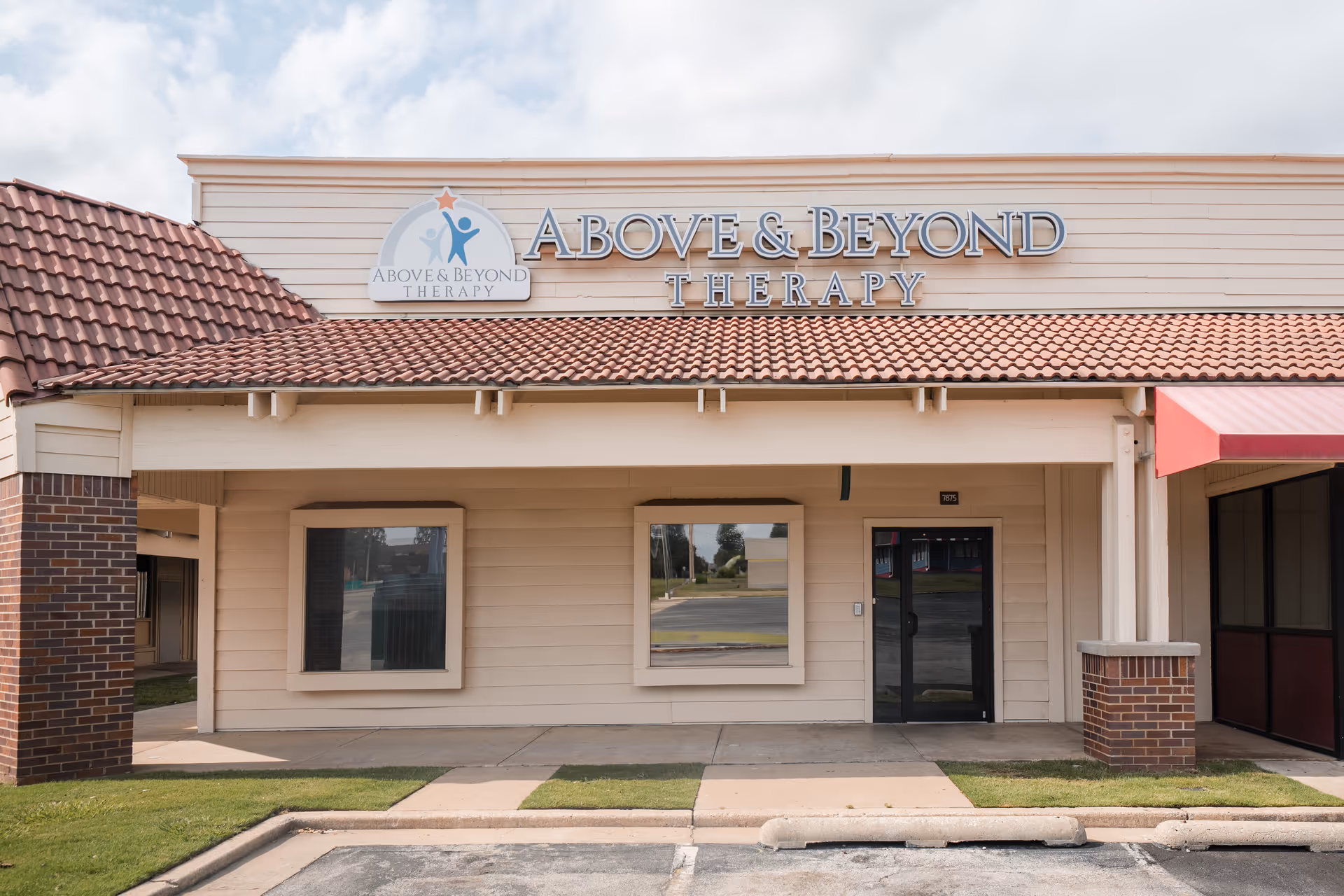 Exterior view of Above and Beyond Therapy building with sign and red-tiled roof