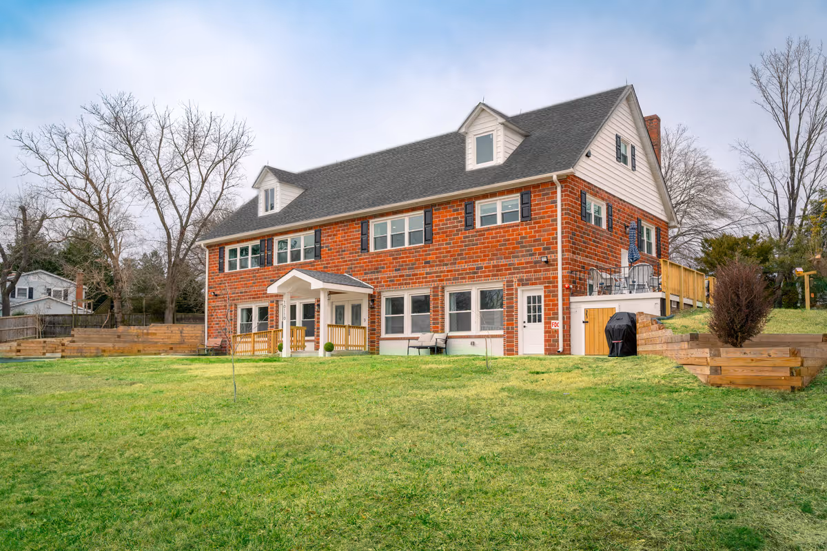 Exterior view of Sequoia Senior Care: brick building with a large grassy yard.