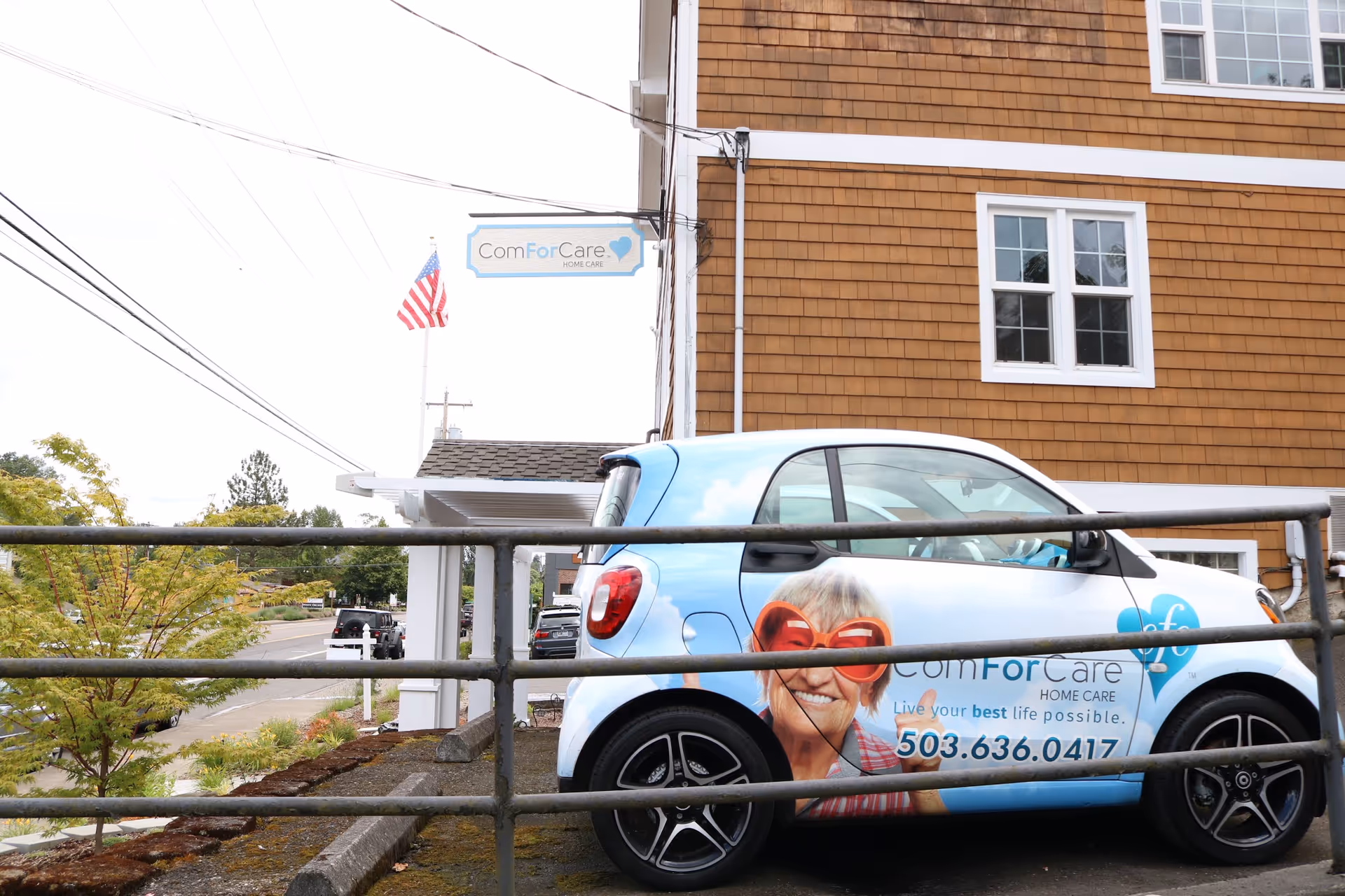 Exterior view of ComForCare building with a branded car in foreground.