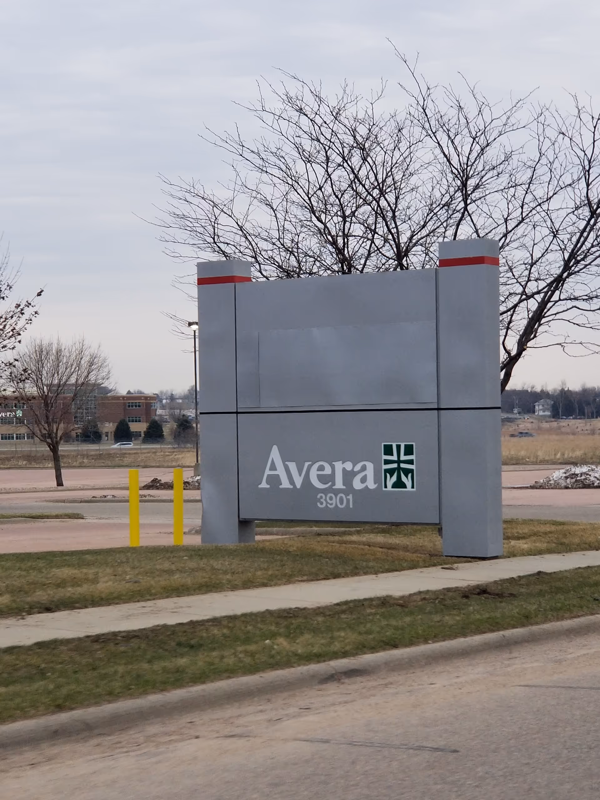 A large Avera sign at the facility entrance with bare trees and overcast sky.