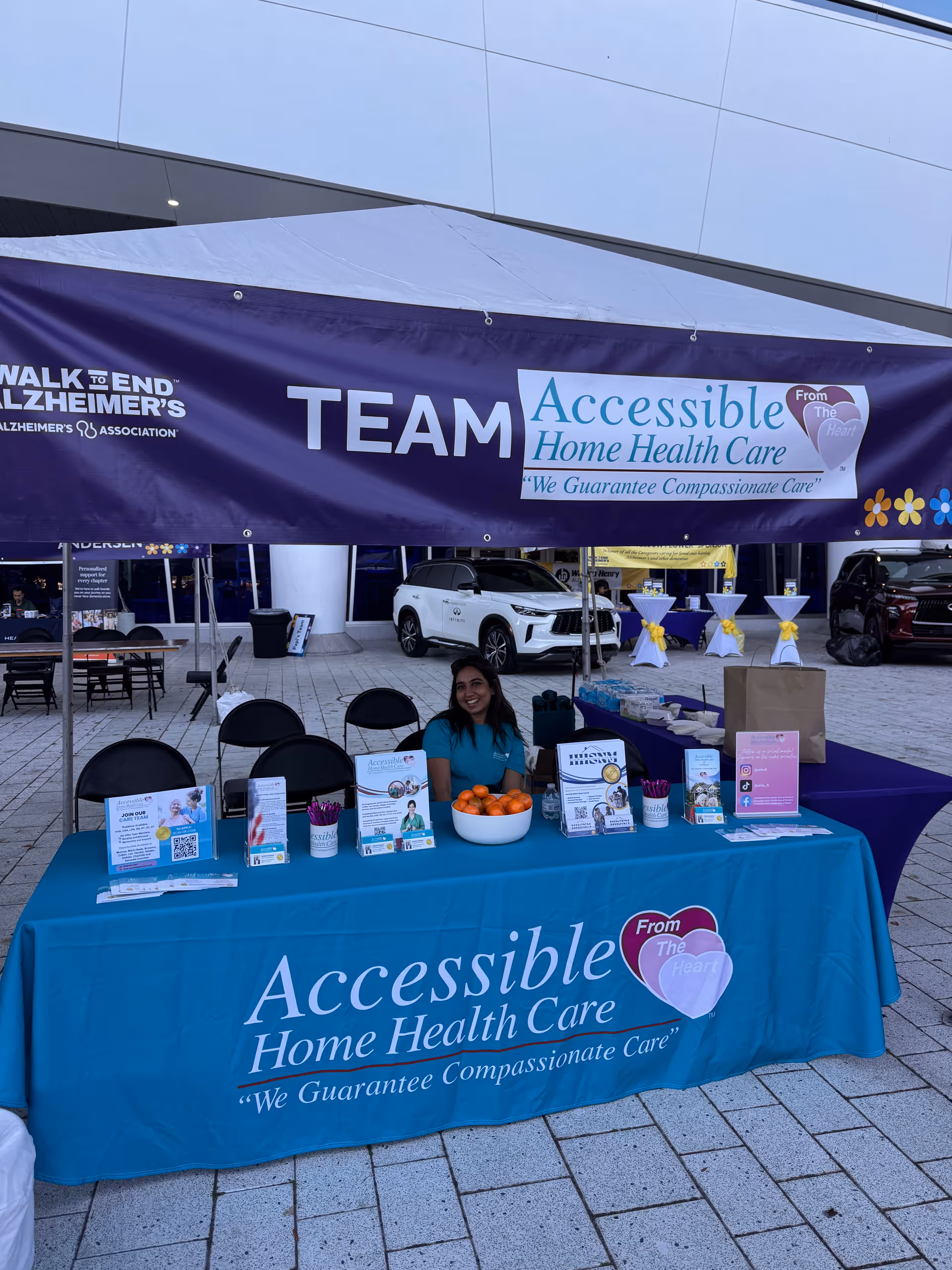 Outdoor booth for Accessible Home Health Care of Broward with banner, tables, and staff.