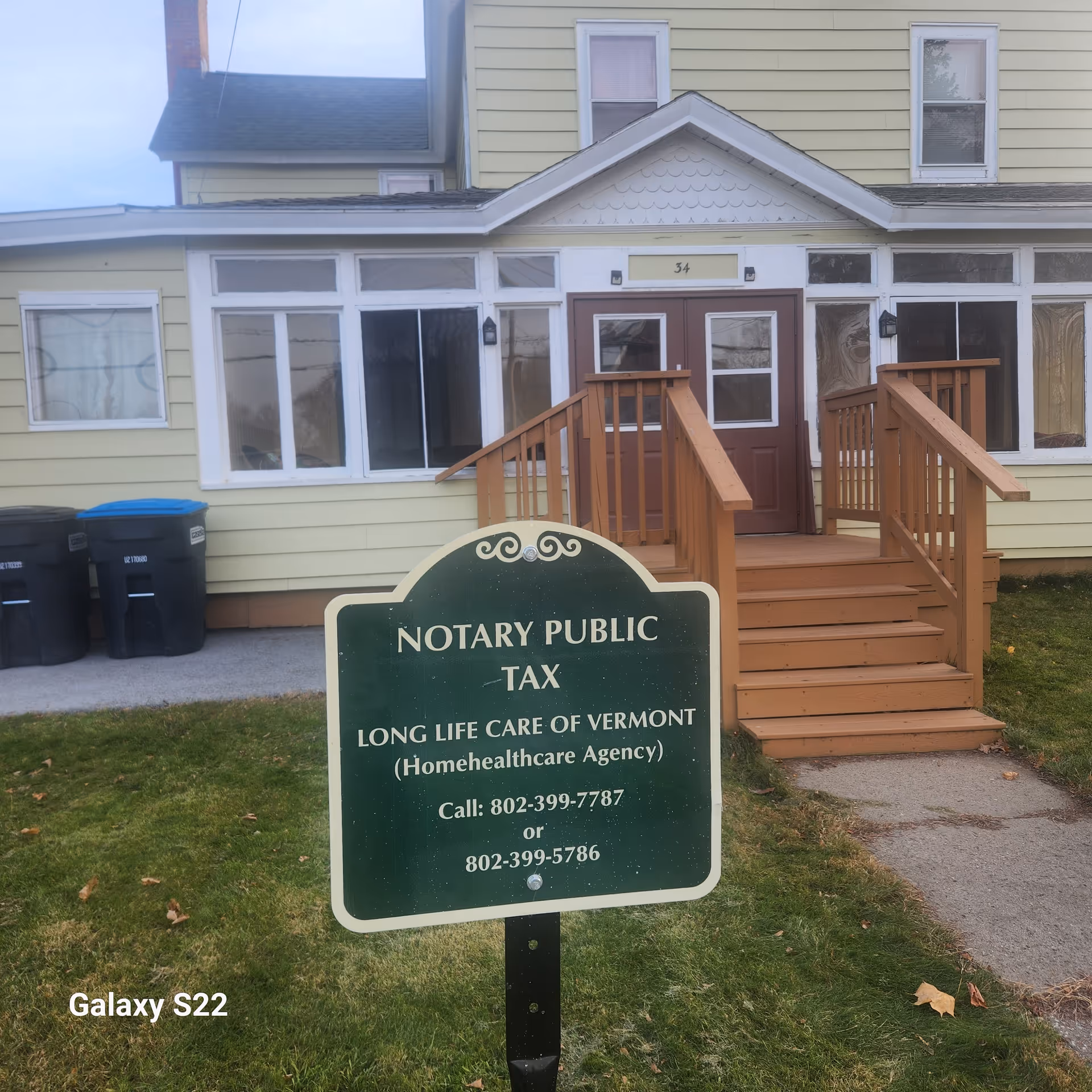 Front view of pale yellow building with wooden stairs and Long Life Care of Vermont sign.