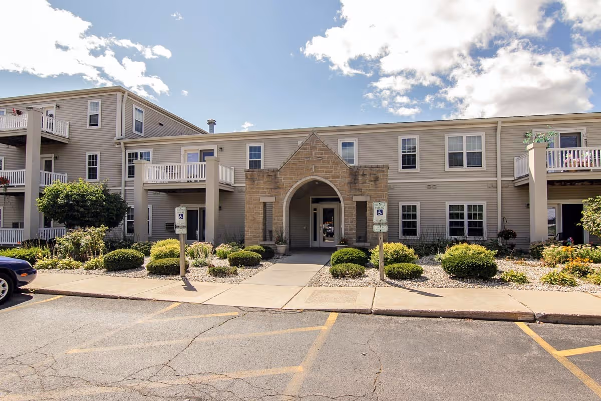 Front exterior of First Senior Apartments I and II with arched entrance.