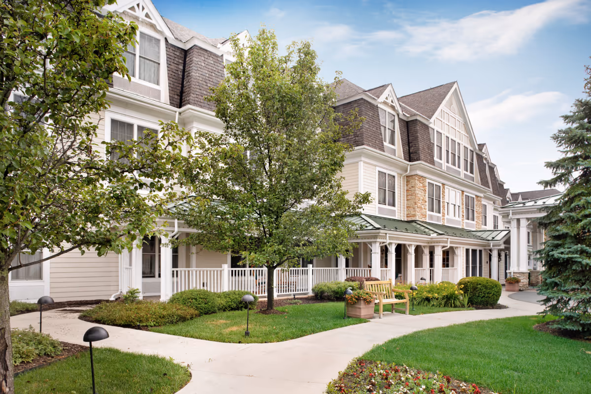 Exterior of Sunrise of Bloomfield Hills, a multi-story senior living building with a porch and landscaping.
