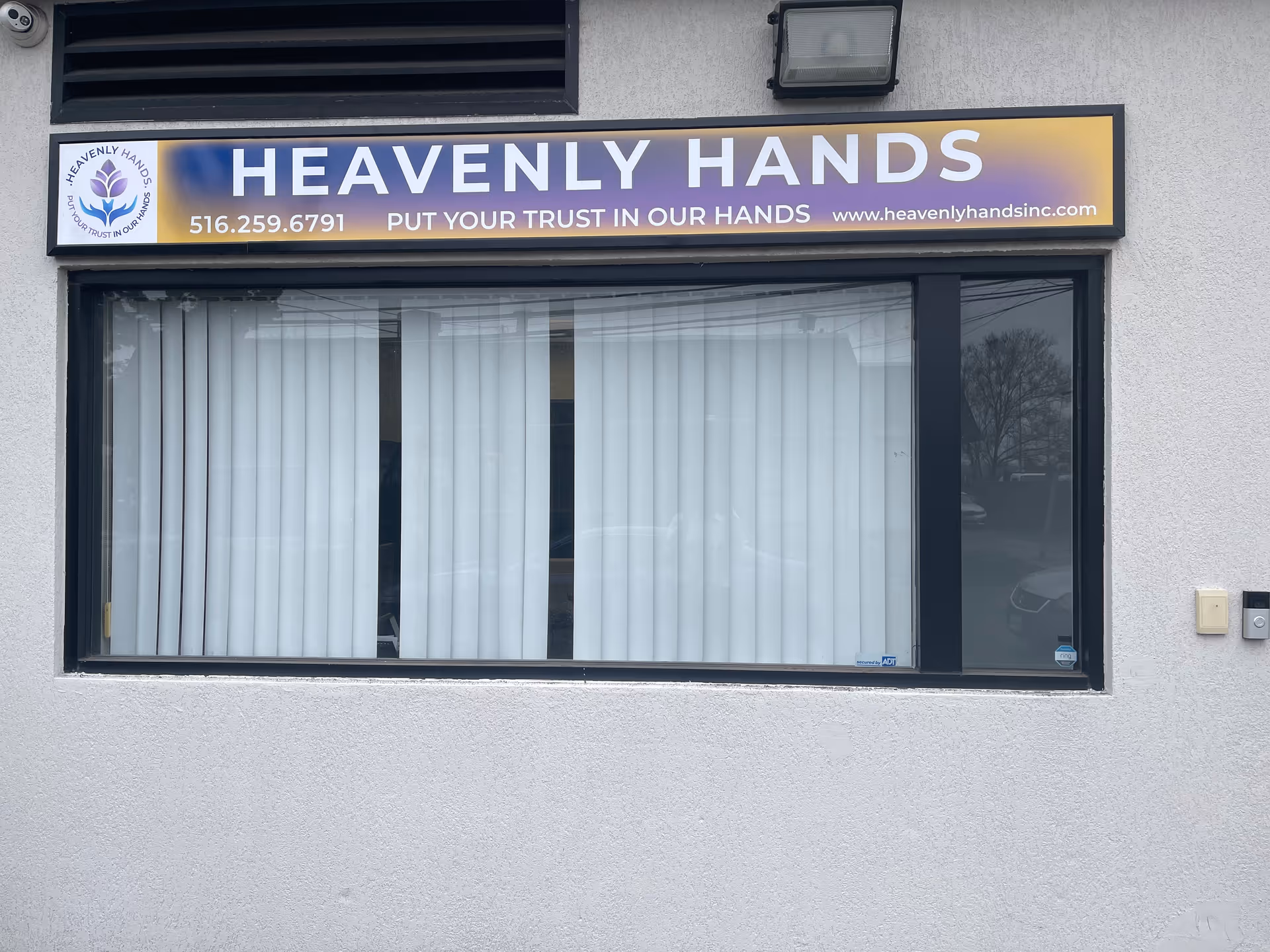 Exterior storefront of Heavenly Hands, Inc. showing sign and window blinds.