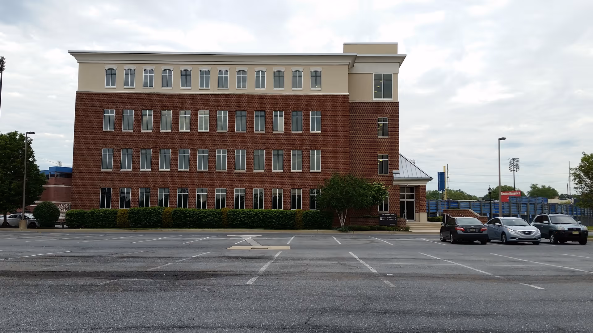 Exterior view of BAYADA Assistive Care building with brick facade and a parking lot.