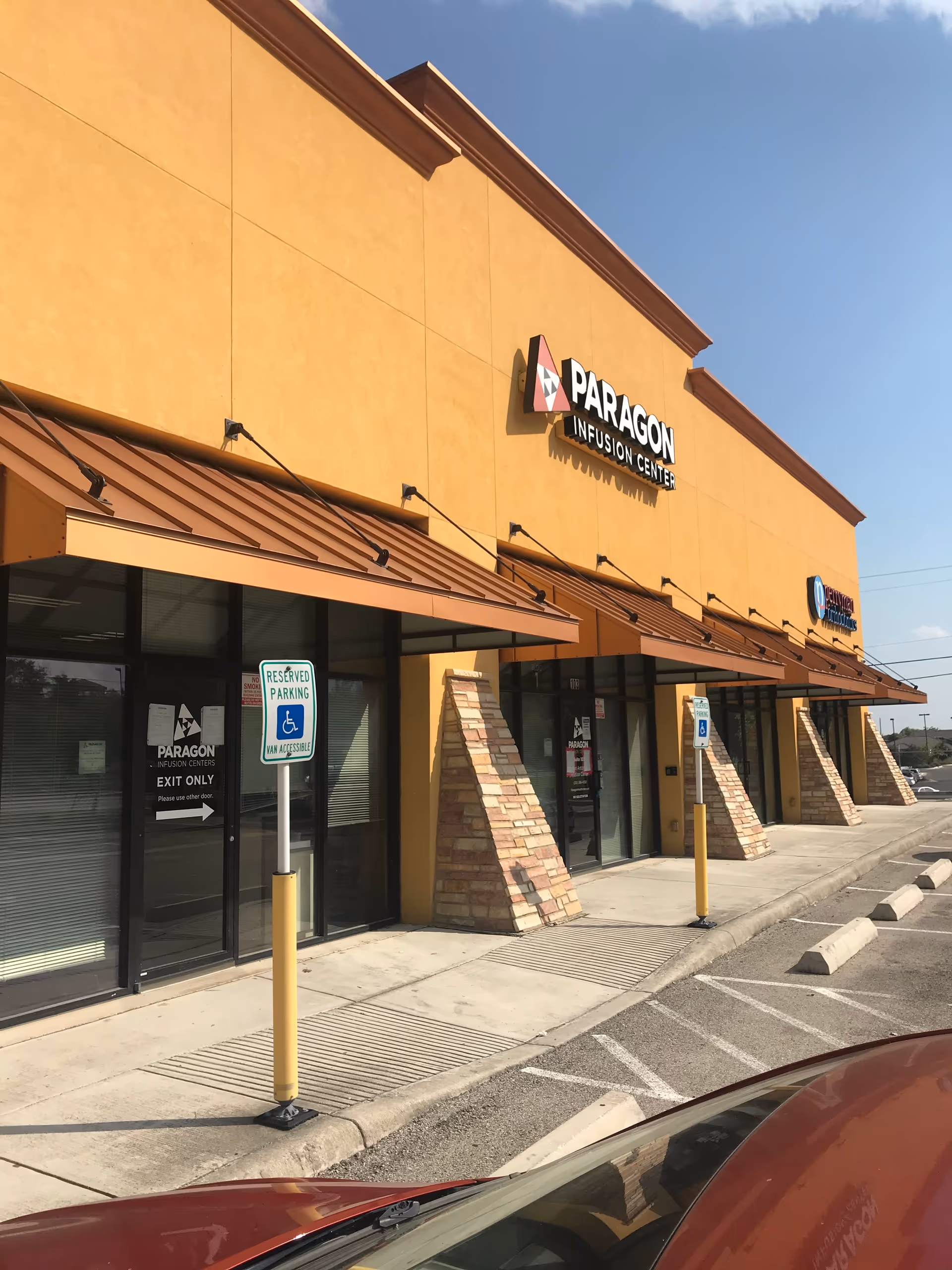 Exterior view of Paragon Infusion Centers storefronts at a strip mall.