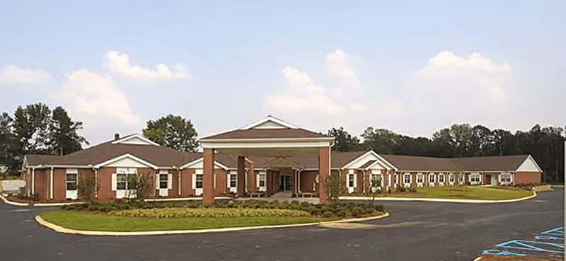 Exterior view of Woodlands Rehabilitation and Healthcare Center, brick senior care facility with circular driveway.
