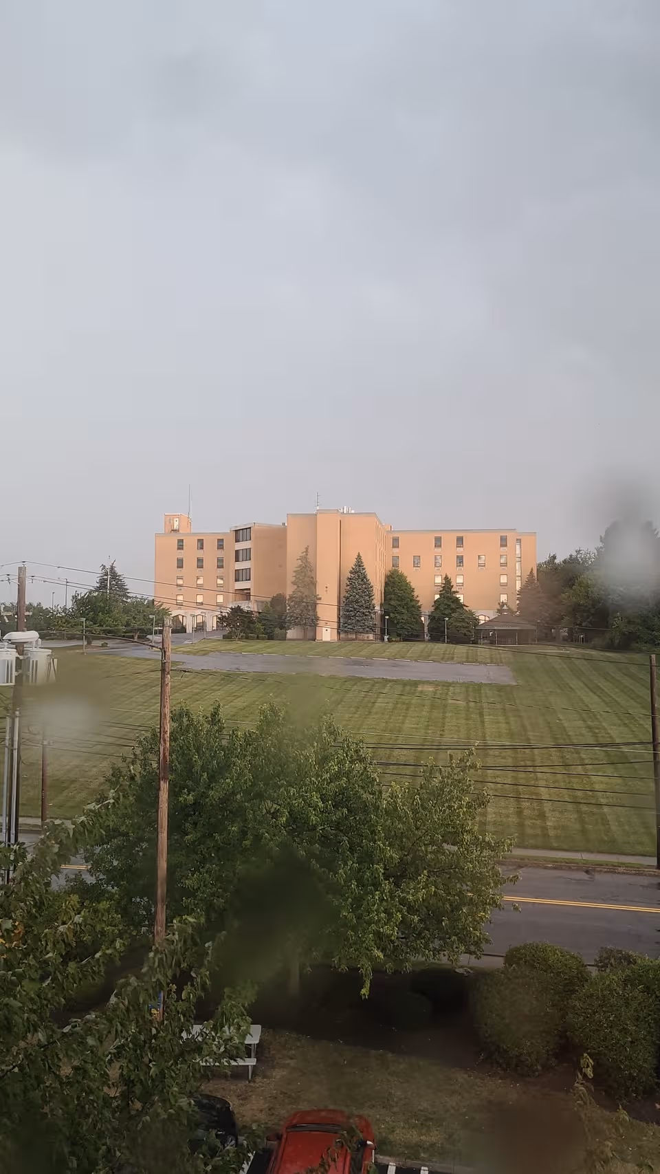 Exterior view of Villa Teresa Nursing Home with grassy foreground and trees