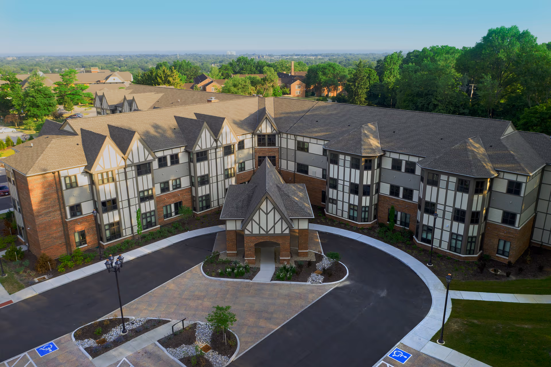 Aerial view of Mcgregor Assisted Living exterior with circular driveway and landscaped grounds.