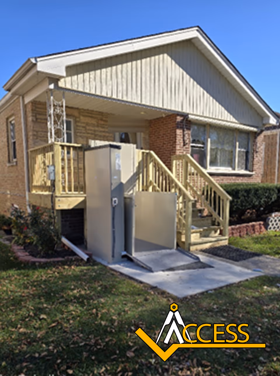 Front exterior of a brick house with a wooden ramp and elevator platform