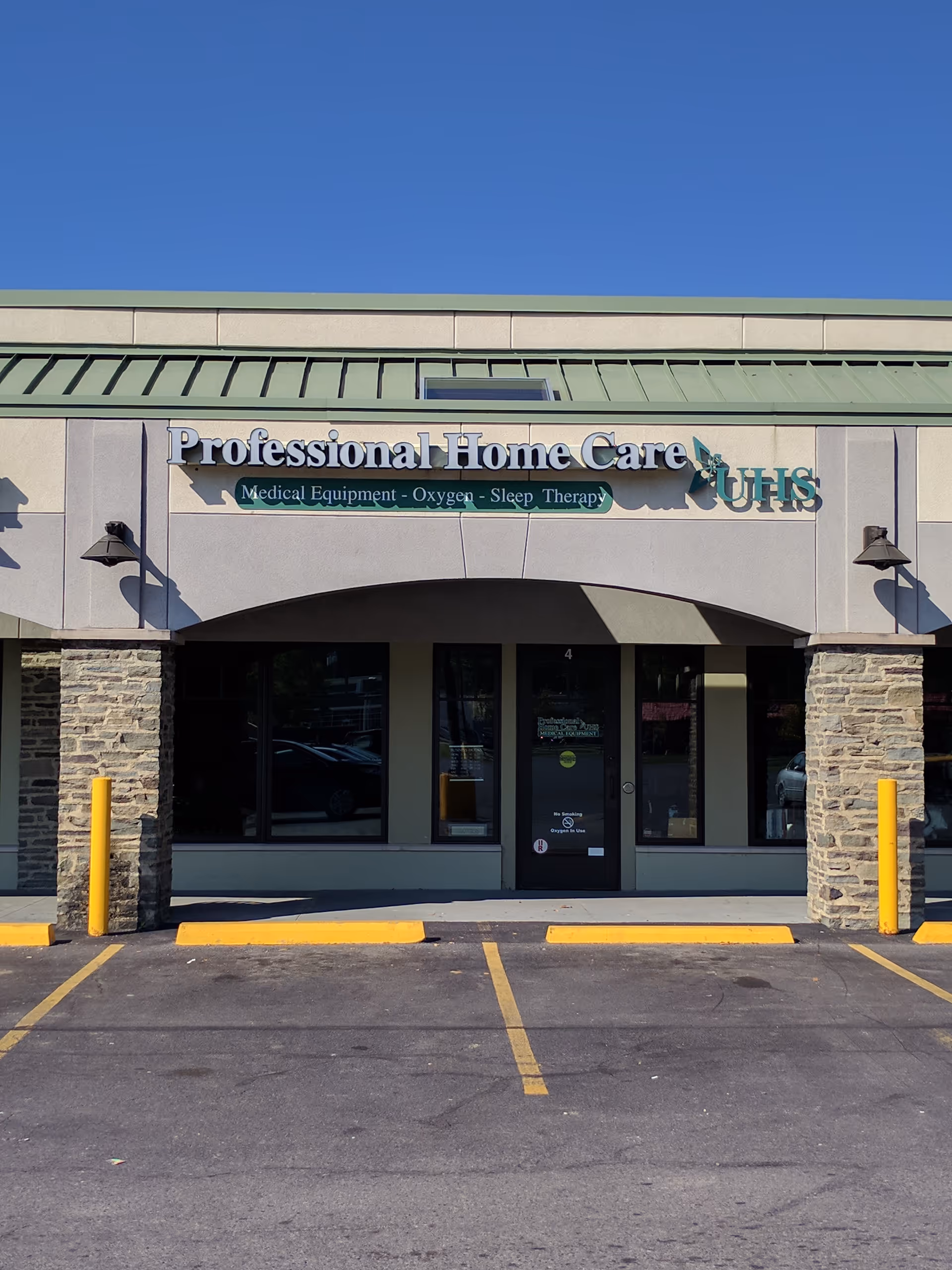 Front view of a beige building with stone accents and 'Professional Home Care' signage.