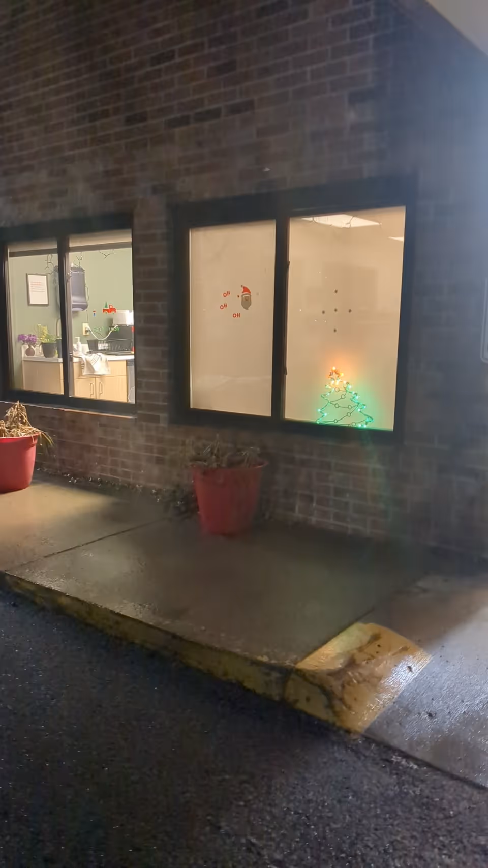 Exterior view of Compassion Care facility with brick wall and lit windows