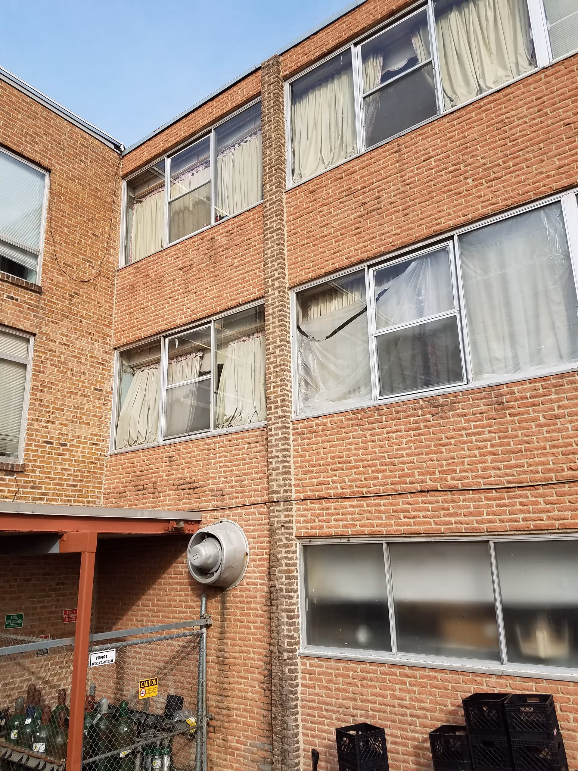 Brick exterior of a multi-story senior care facility with numerous windows.