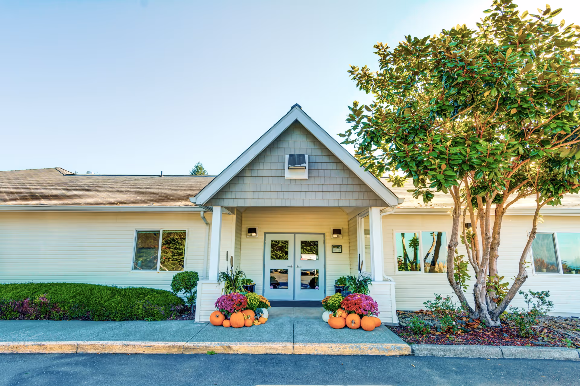 Front entrance of Ashley Manor Irma 1, with pumpkins and fall landscaping.